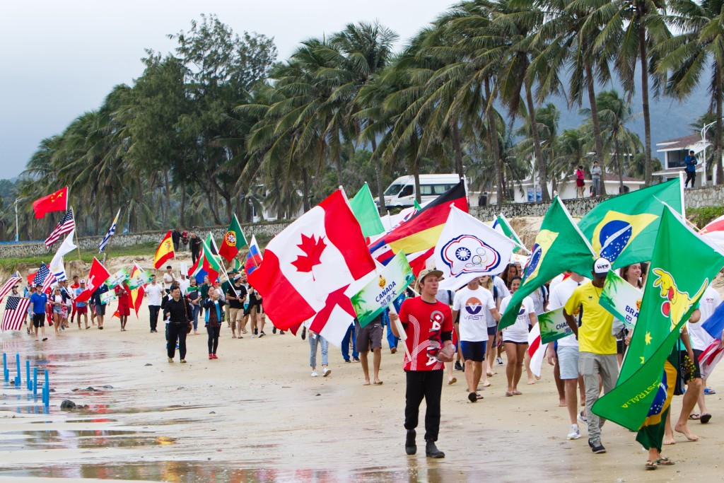 The festive Parade of Nations heads down the beach at Riyue Bay en route to the Opening Ceremony stage. Photo: ISA / Tim Hain