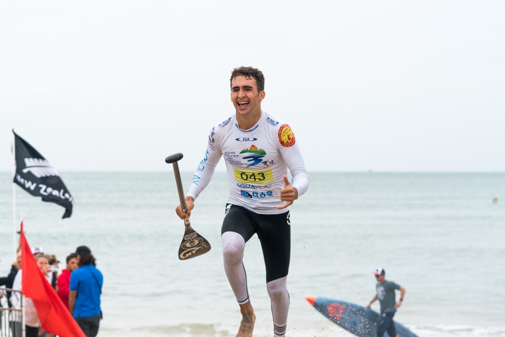 USA’s Ryan Funk crosses the finish line as the first-ever Junior Boys SUP Technical Race World Champion. Photo: ISA / Sean Evans