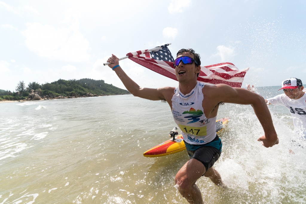 USA’s Hunter Pflueger flies his flag with pride as he earns a Gold Medal. Photo: ISA / Sean Evans  