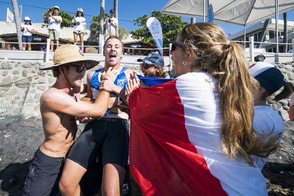 Julen Marticorena is mobbed by Team France after winning the Men’s Paddleboard Gold. Photo: ISA / Ben Reed 